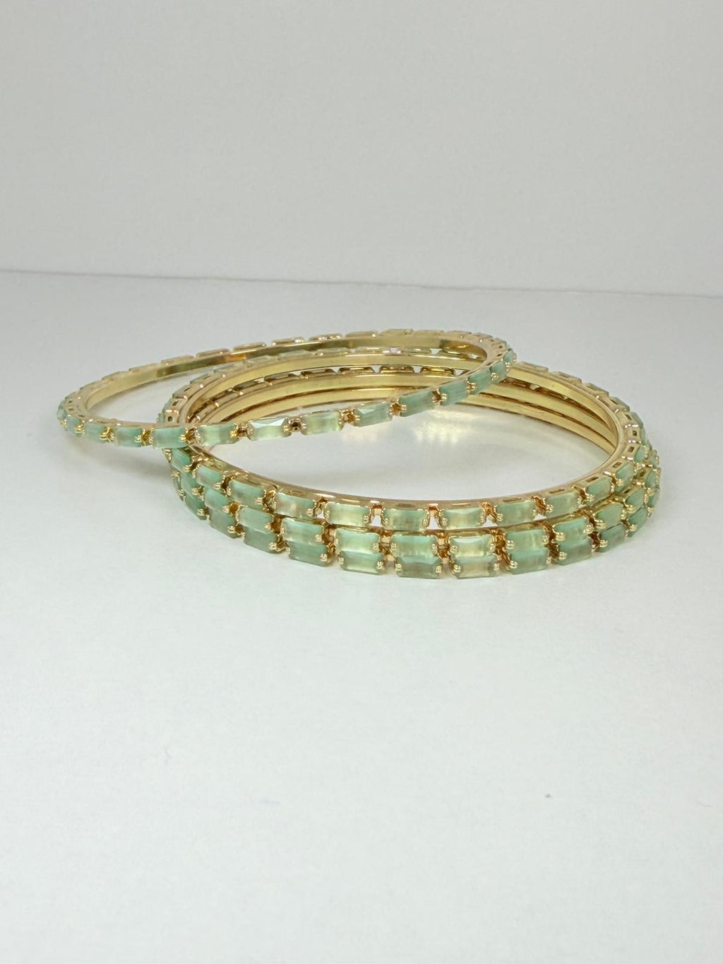 Stunning mint‑green crystal bangles set in gold‑tone metal
