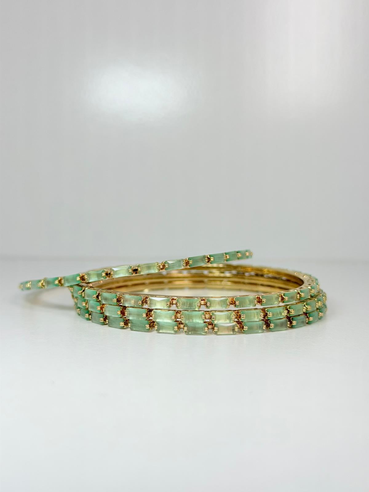 Stunning mint‑green crystal bangles set in gold‑tone metal