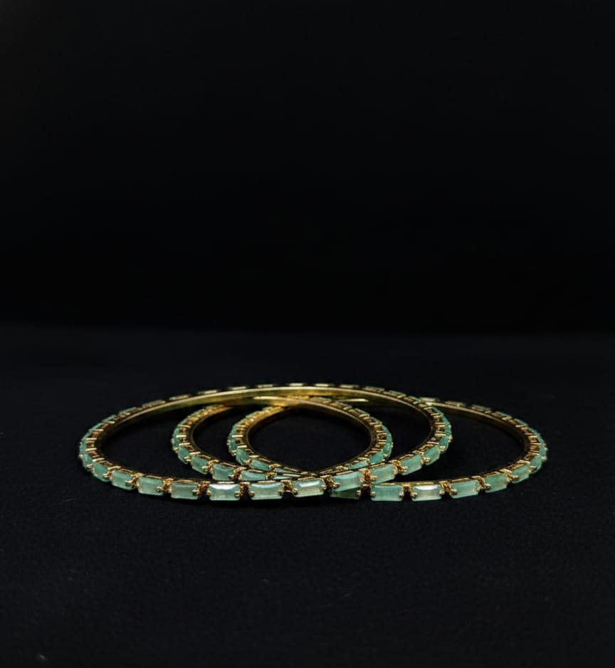Stunning mint‑green crystal bangles set in gold‑tone metal