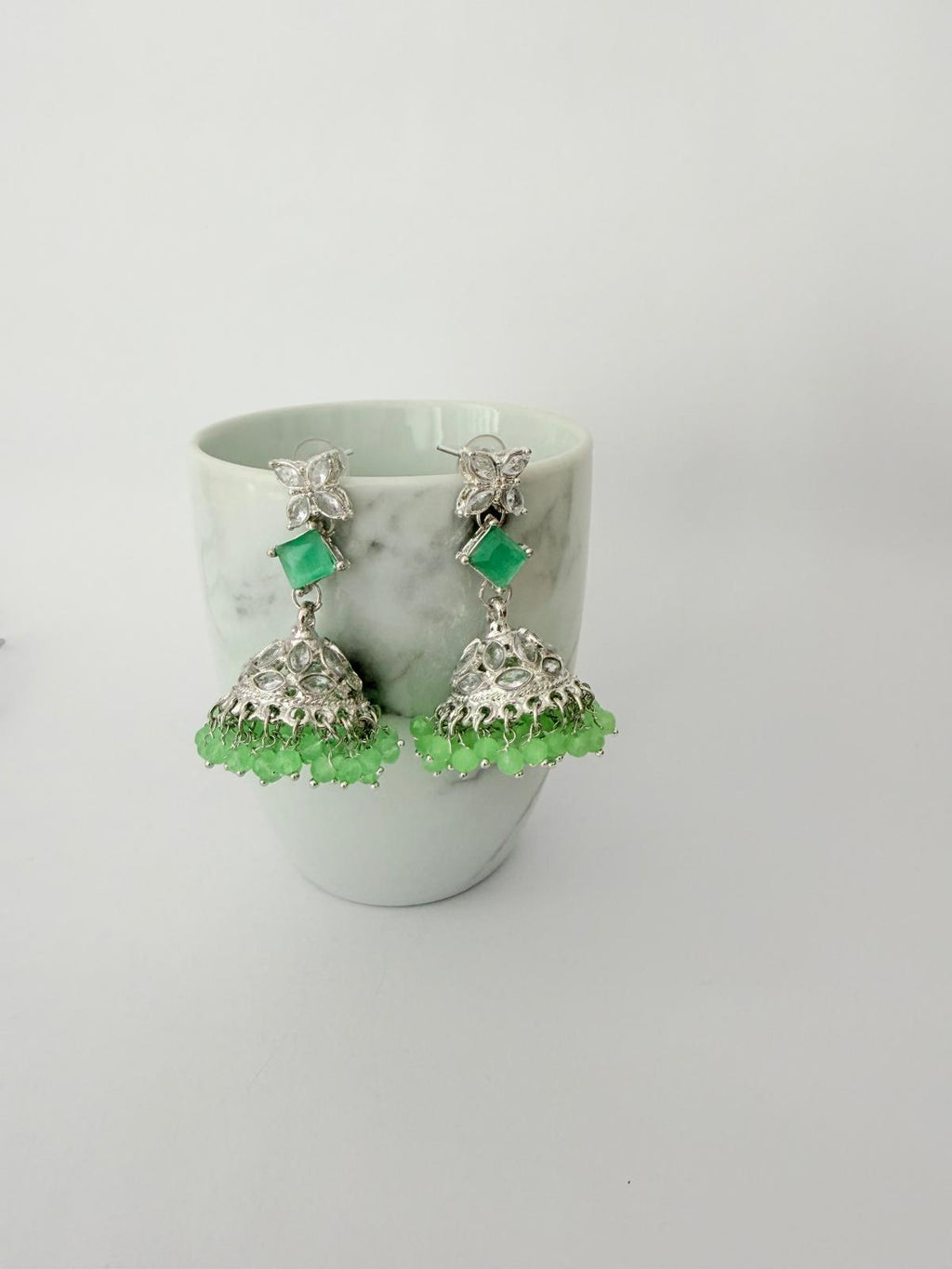 Stunning silver-toned necklace set with vibrant green gemstones