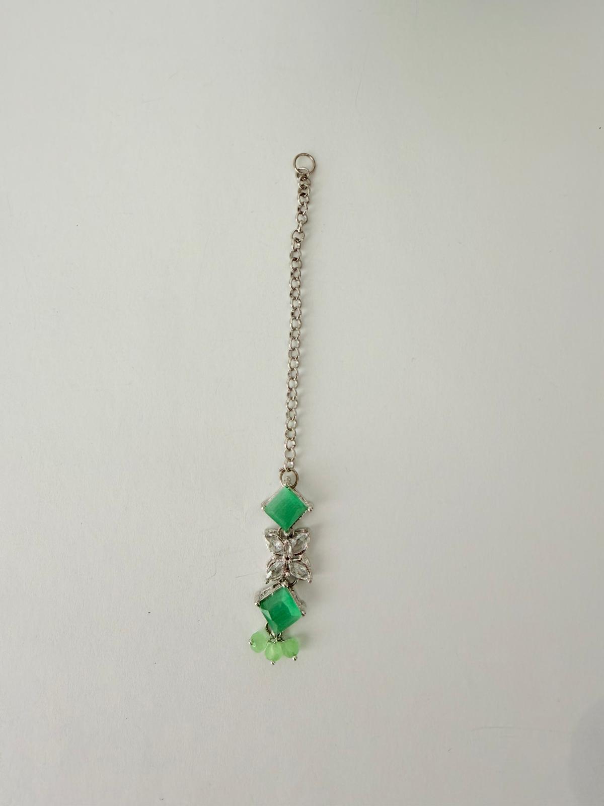Stunning silver-toned necklace set with vibrant green gemstones